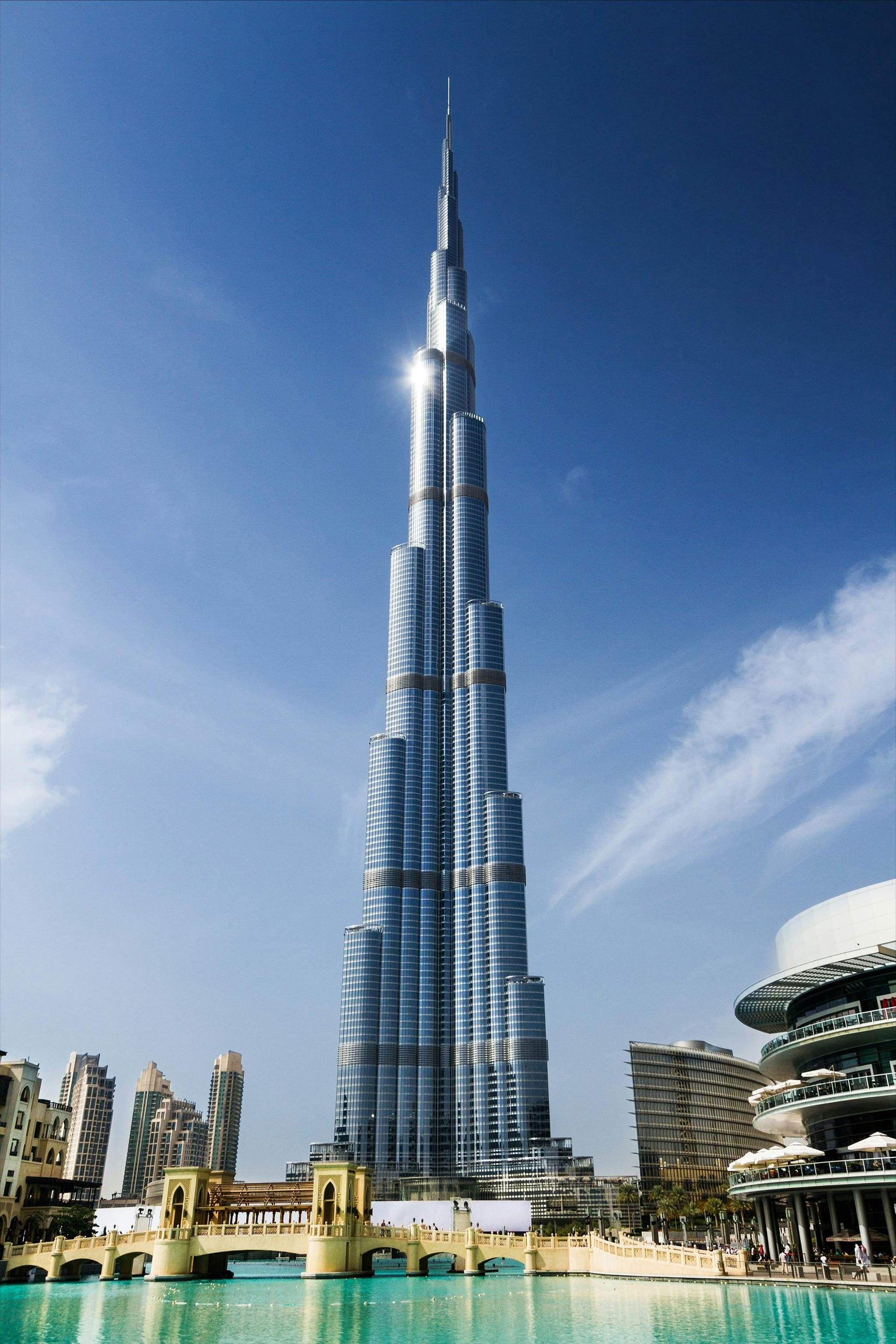 A tall building with many windows with Burj Khalifa in the background

AI-generated content may be incorrect.